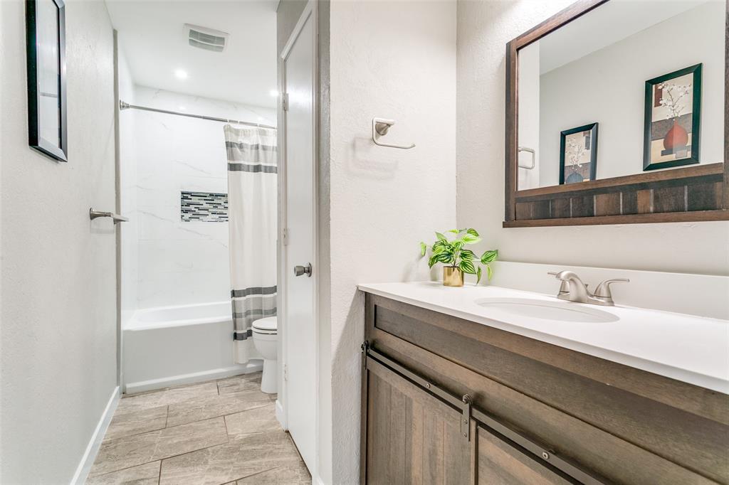 200 Lark Lane Euless, TX 76039 - Photo 20 of 25 a bathroom with a sink a toilet and shower