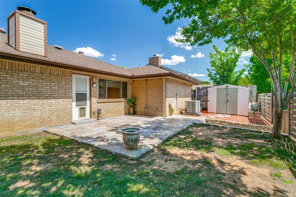 200 Lark Lane Euless, TX 76039 - Photo 22 of 25 a front view of a house with a yard and garage