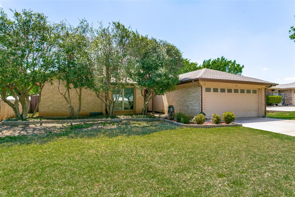 200 Lark Lane Euless, TX 76039 - Photo 3 of 25 a view of a house with a yard and garage