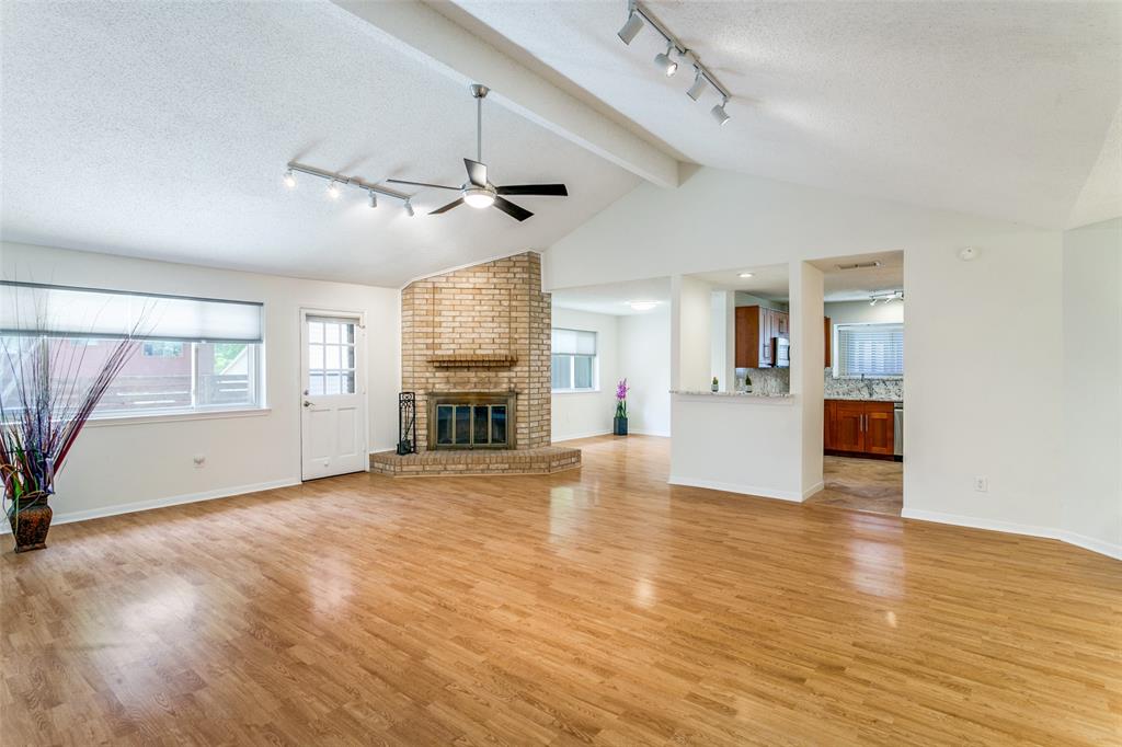 200 Lark Lane Euless, TX 76039 - Photo 8 of 25 a view of empty room with wooden floor and fireplace