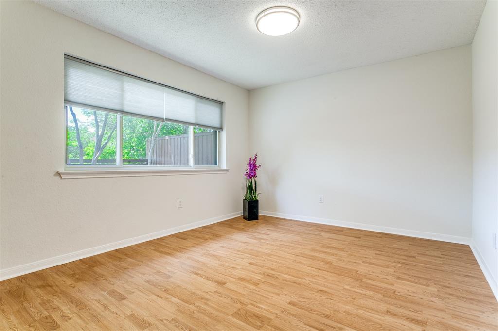 200 Lark Lane Euless, TX 76039 - Photo 9 of 25 an empty room with wooden floor and windows