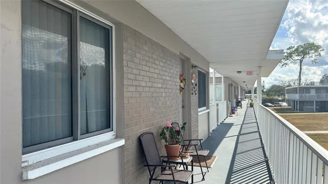 a view of a porch with chairs and backyard