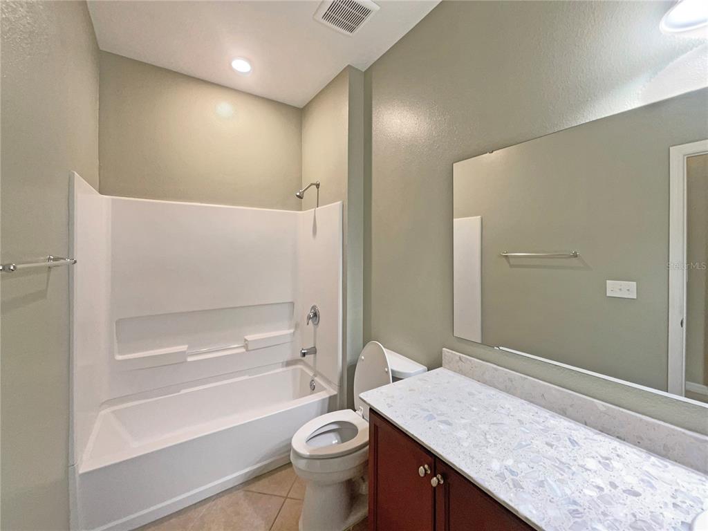 10017 Weathers Loop Clermont, FL 34711 - Photo 12 of 23 a bathroom with a granite countertop sink toilet and shower