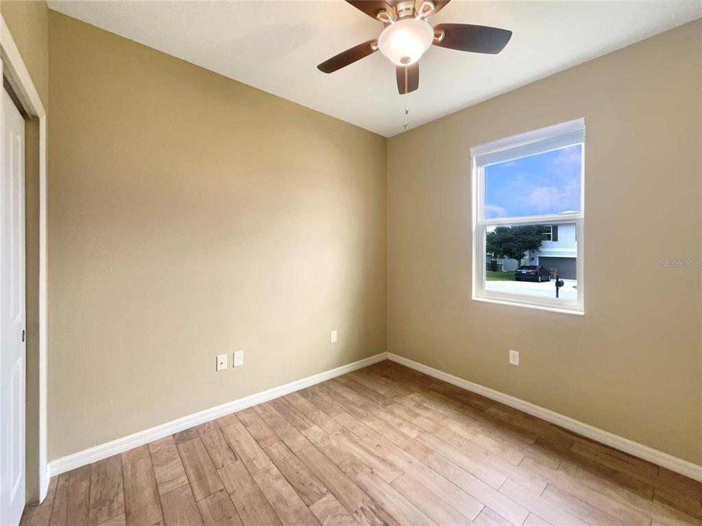 10017 Weathers Loop Clermont, FL 34711 - Photo 17 of 23 a view of an empty room with a window and wooden floor