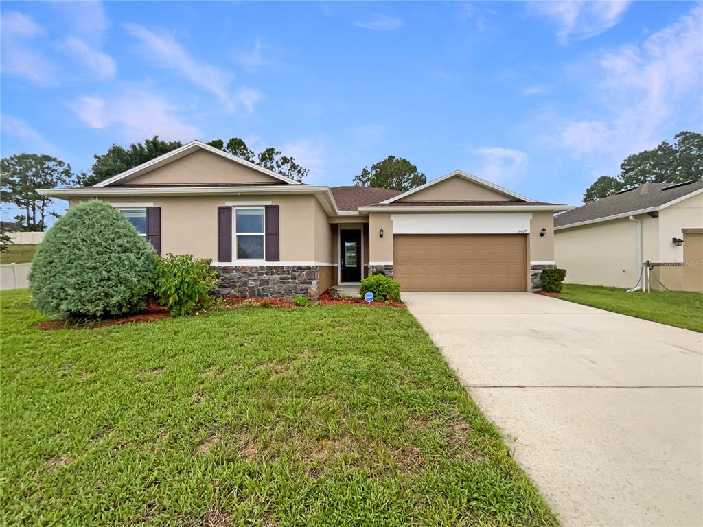 10017 Weathers Loop Clermont, FL 34711 - Photo 20 of 23 a front view of a house with a garden