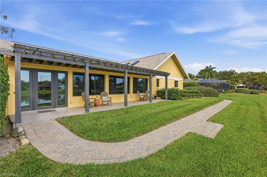 2274 Queens Way Naples, FL 34112 - Photo 26 of 28 front view of a house with a yard