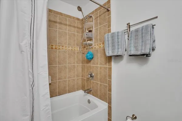 a bathroom with a bathtub and shower