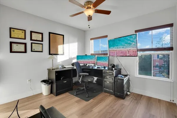 a view of a workspace with furniture and a window