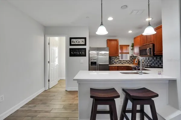 a large kitchen with a table and chairs