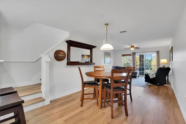 a view of a dining room with furniture and wooden floor