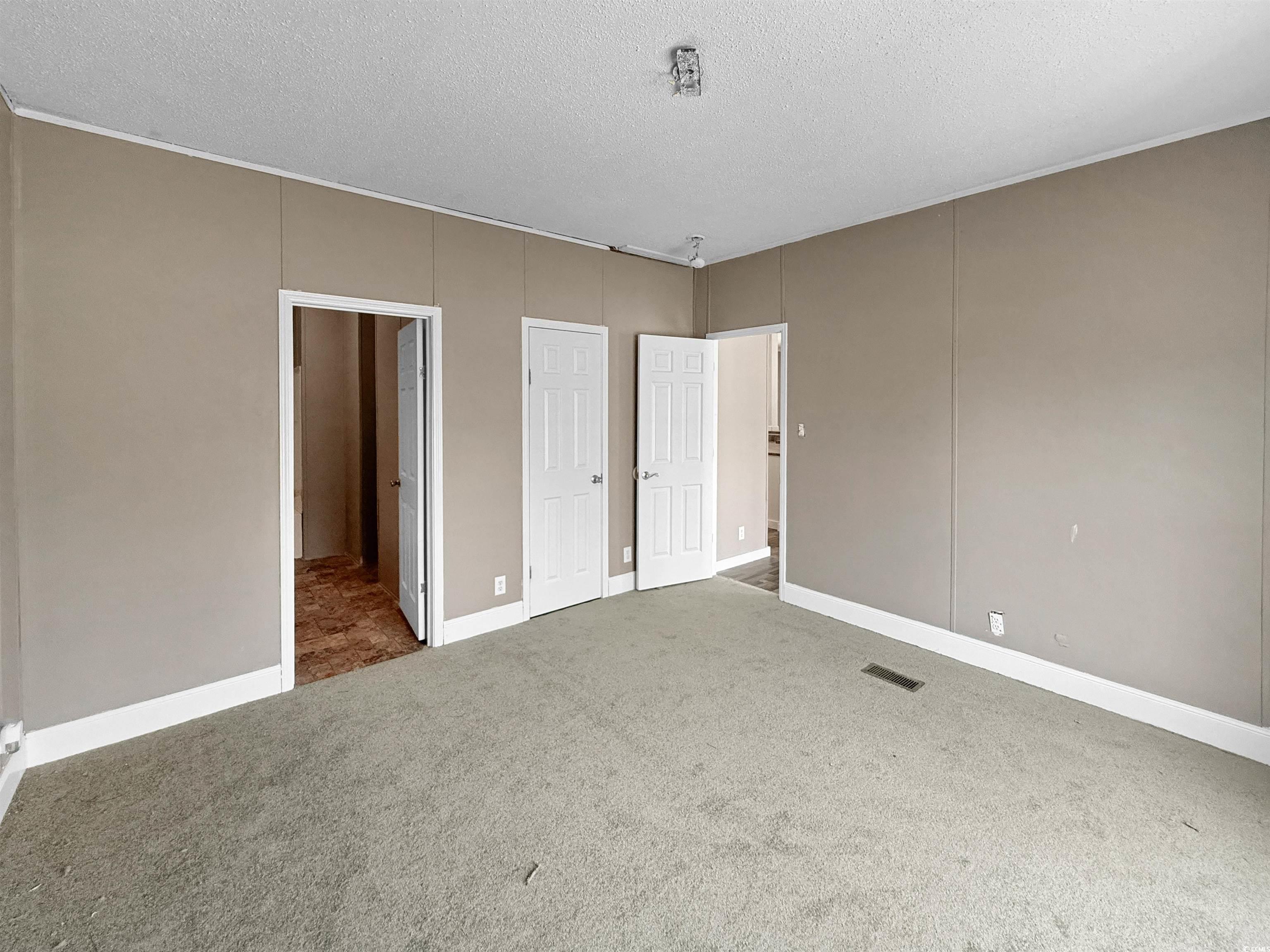 111 Morrisville Road Andrews, SC 29510 - Photo 15 of 28 Unfurnished bedroom with a textured ceiling, carpet flooring, and visible vents