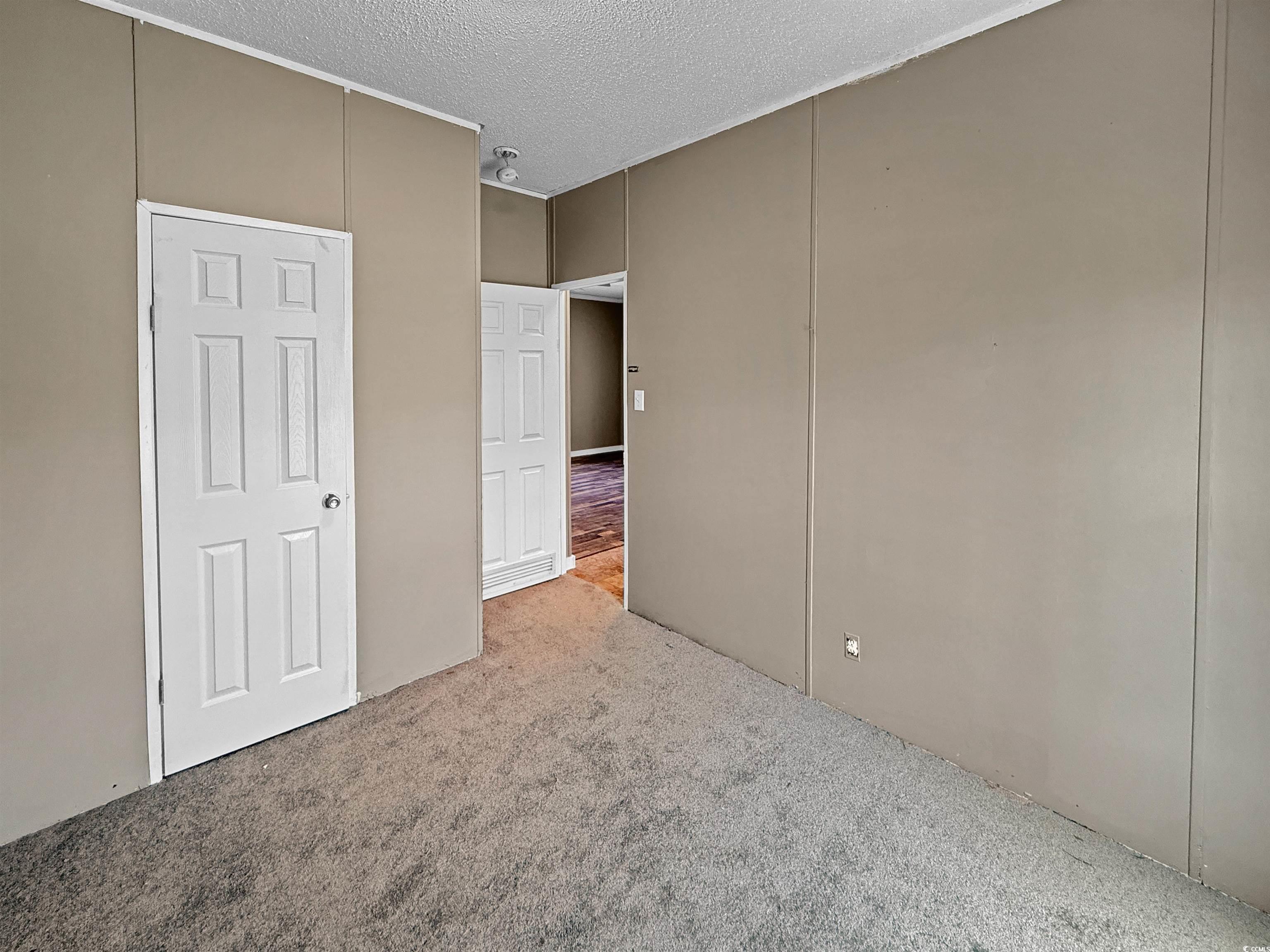 111 Morrisville Road Andrews, SC 29510 - Photo 16 of 28 Interior space featuring carpet and a textured ceiling