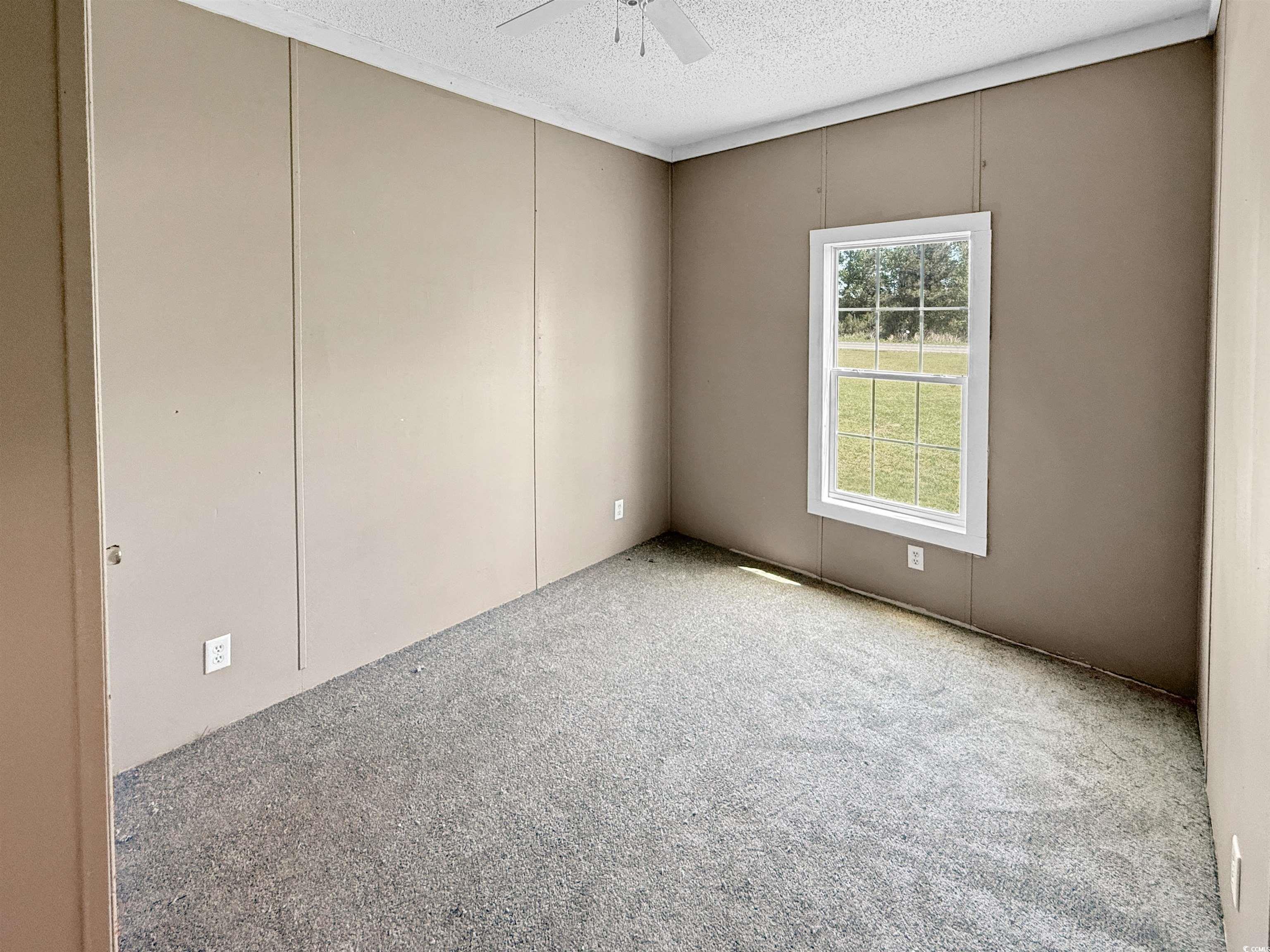 111 Morrisville Road Andrews, SC 29510 - Photo 19 of 28 Carpeted spare room with a textured ceiling and ceiling fan