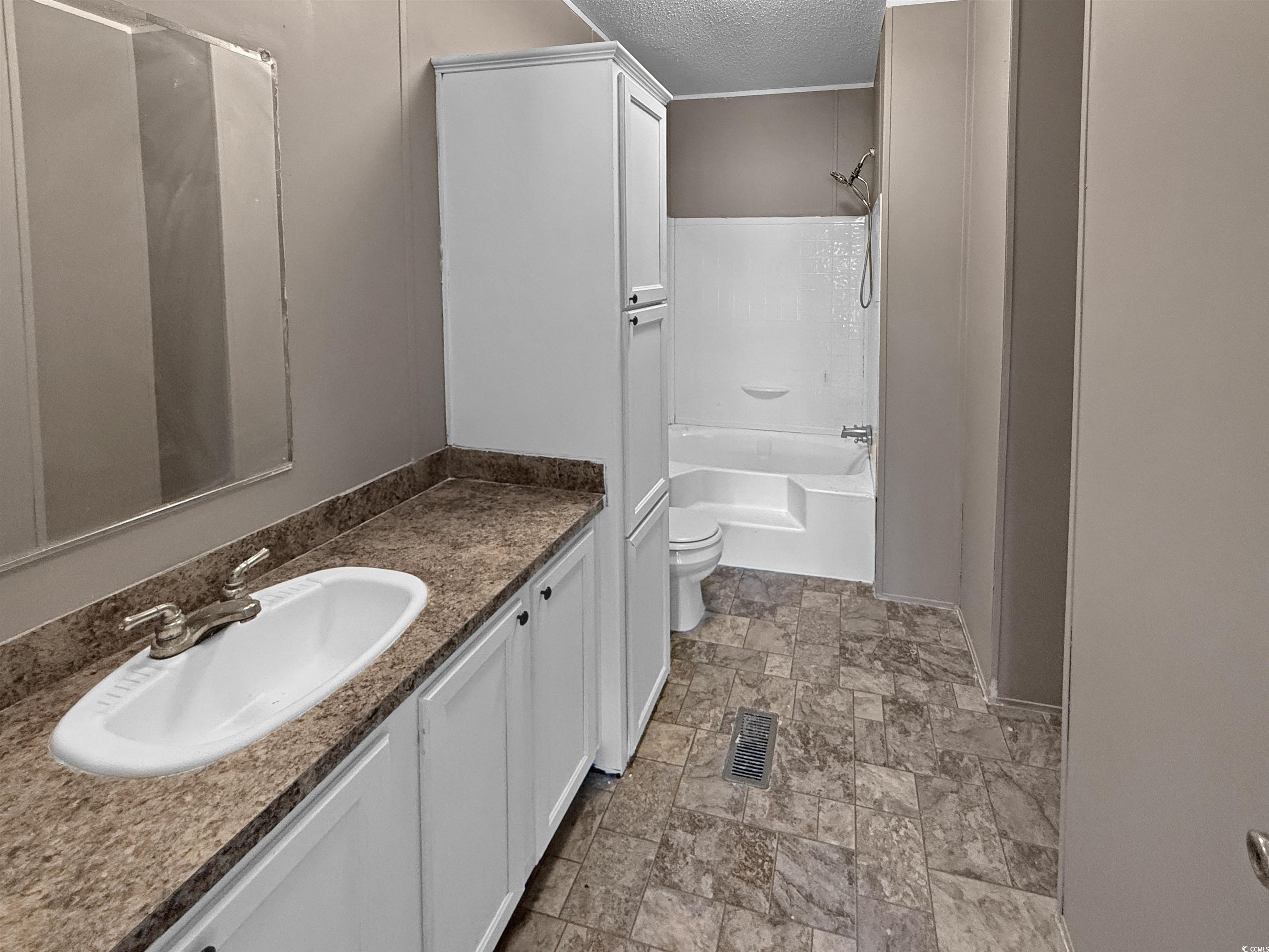 111 Morrisville Road Andrews, SC 29510 - Photo 22 of 28 Full bathroom featuring visible vents, toilet, tub / shower combination, a textured ceiling, and vanity