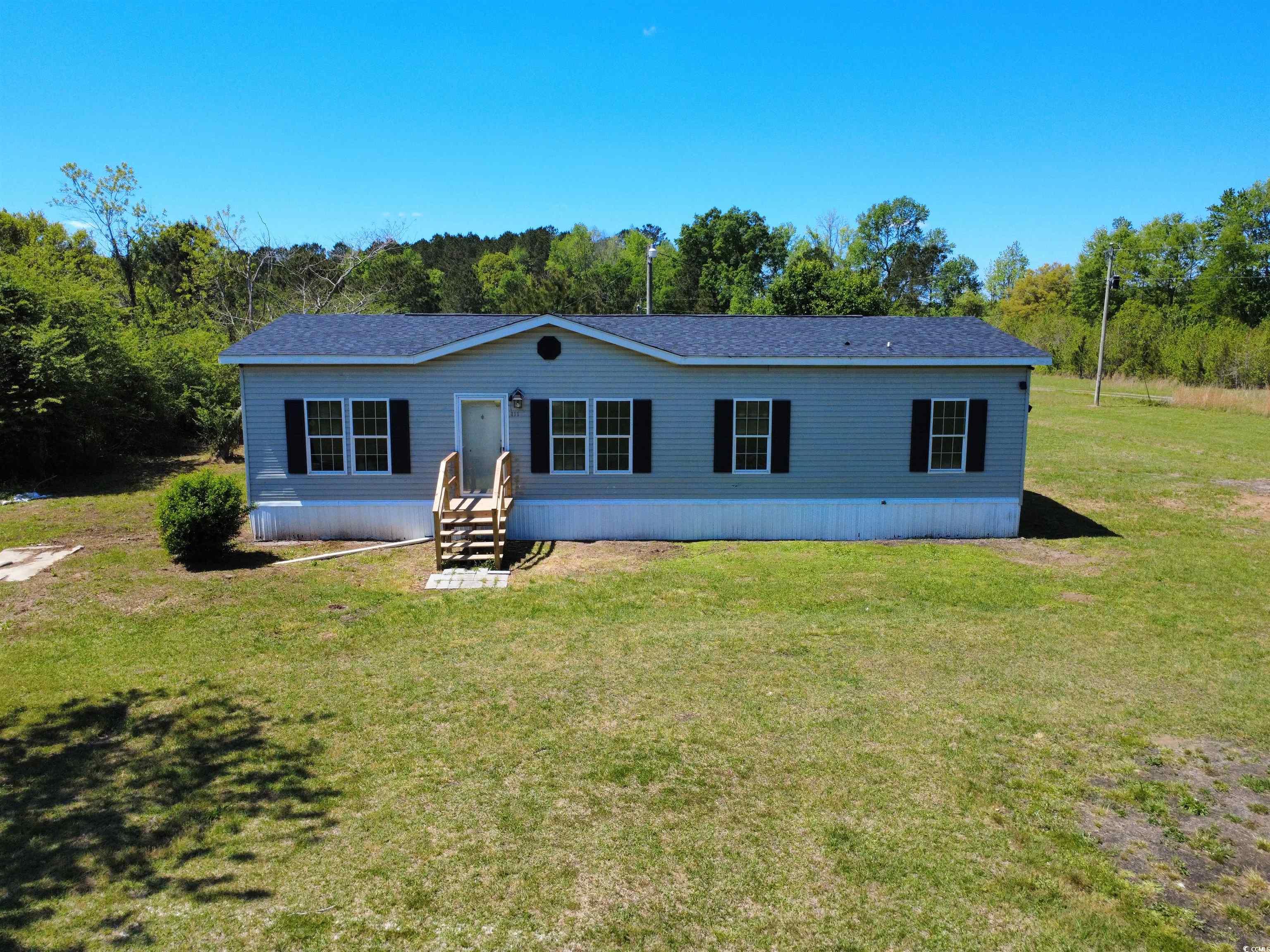 111 Morrisville Road Andrews, SC 29510 - Photo 3 of 28 Back of property with a yard and entry steps