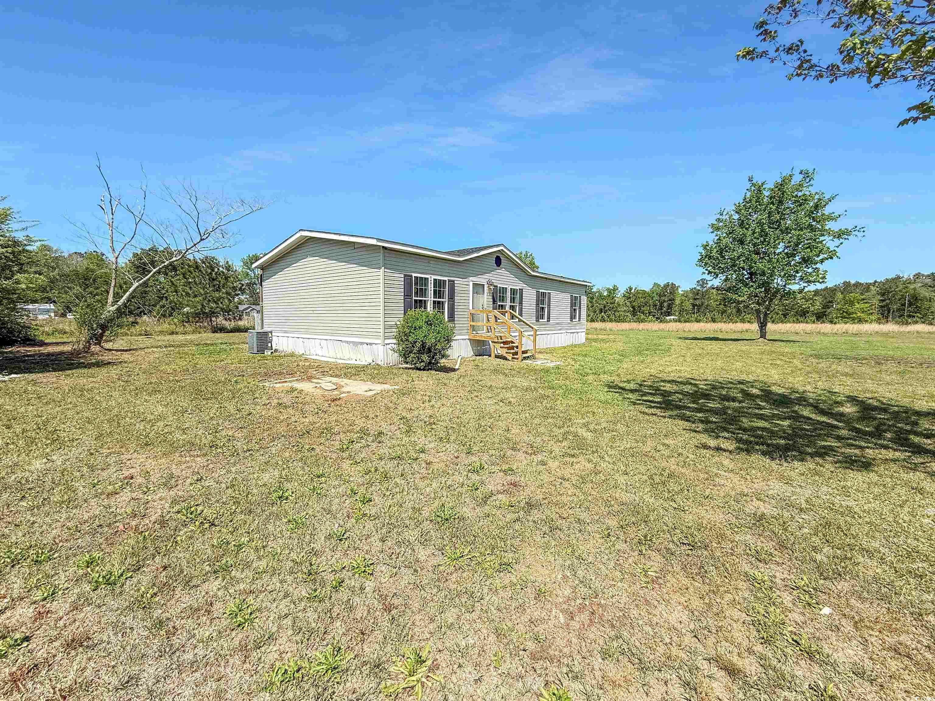 111 Morrisville Road Andrews, SC 29510 - Photo 5 of 28 View of property exterior with cooling unit and a lawn