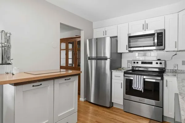 a kitchen with stainless steel appliances a stove microwave and refrigerator