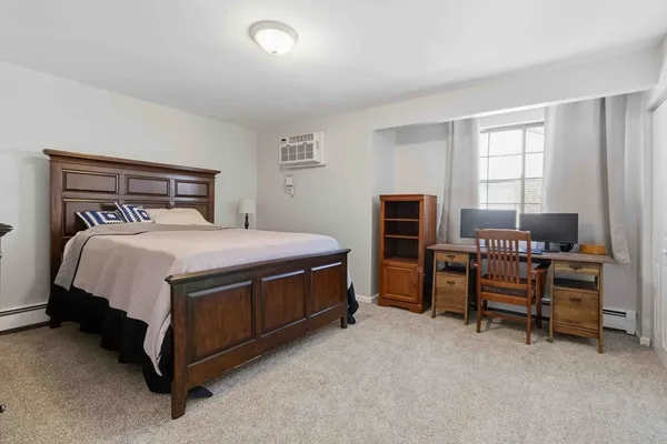 a bedroom with a bed and a couch