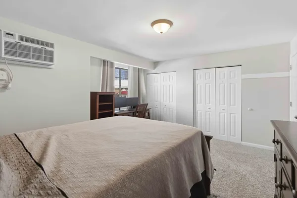 a bedroom with a bed and a dresser