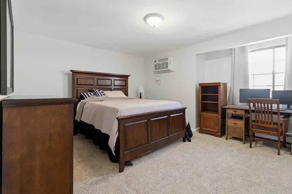 a bed sitting in a bedroom next to a window