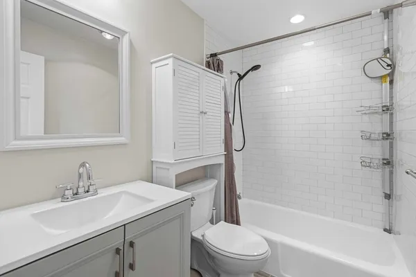 a bathroom with a sink toilet tub and shower