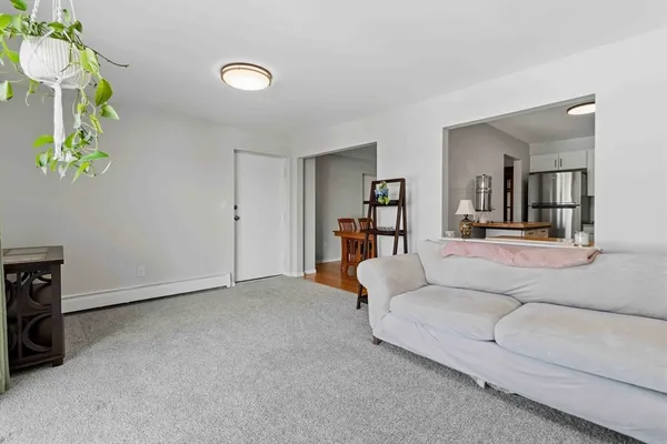 a living room with furniture and a chandelier
