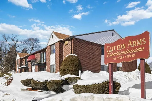 a street sign on a pole next to a building
