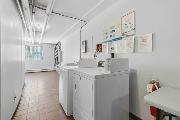 a kitchen with a sink a refrigerator and cabinets