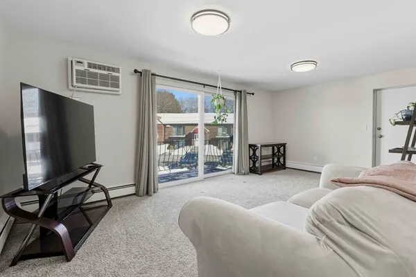 a bedroom with furniture and a flat screen tv