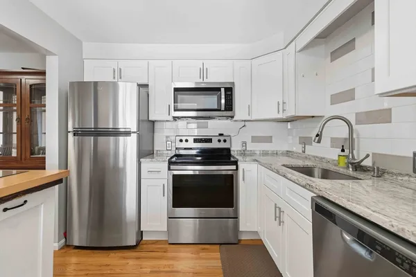 a kitchen with a refrigerator stove and sink