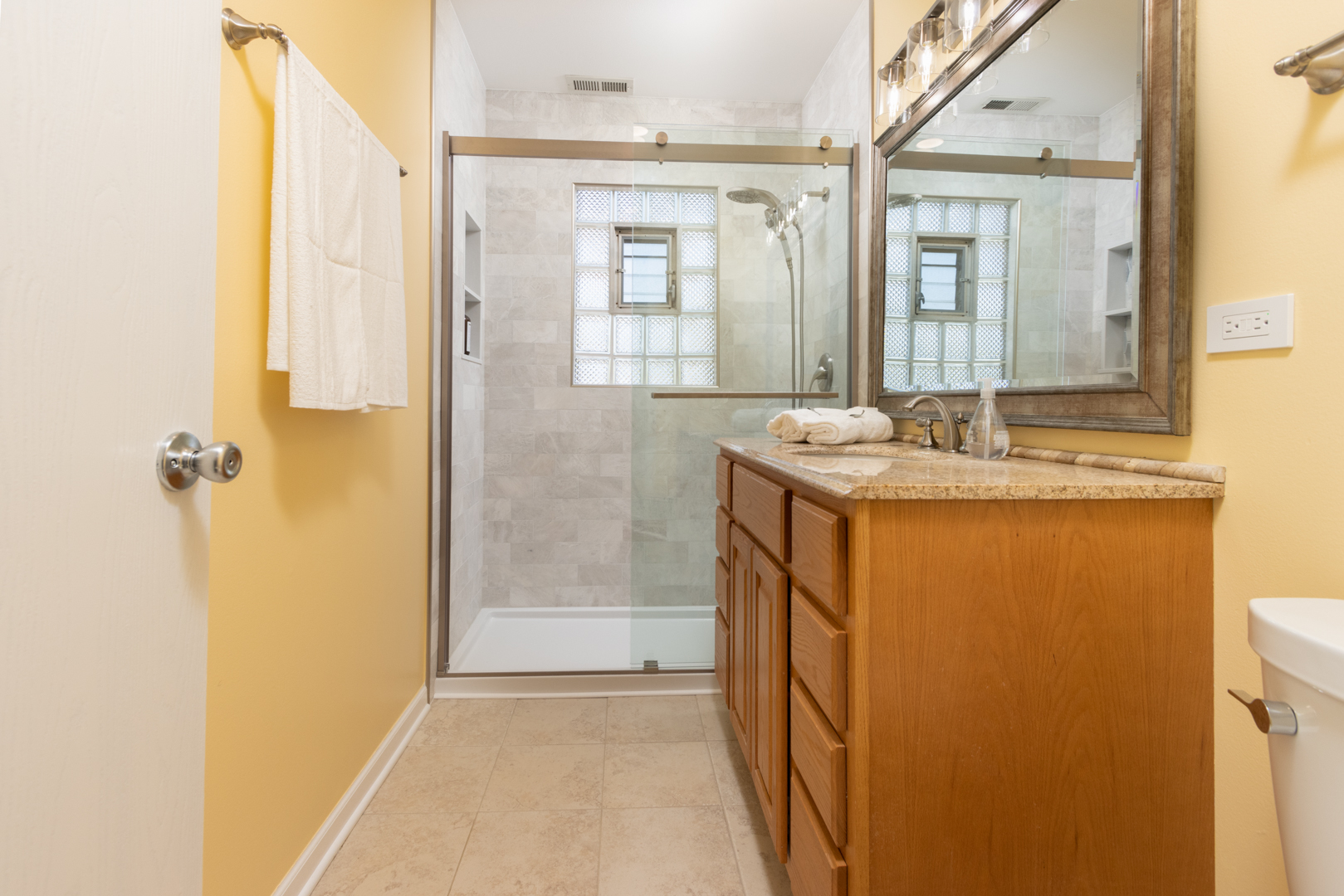 845 Deerpath Lane Hoffman Estates, IL 60169 - Photo 14 of 27 a bathroom with a granite countertop sink a mirror and a shower