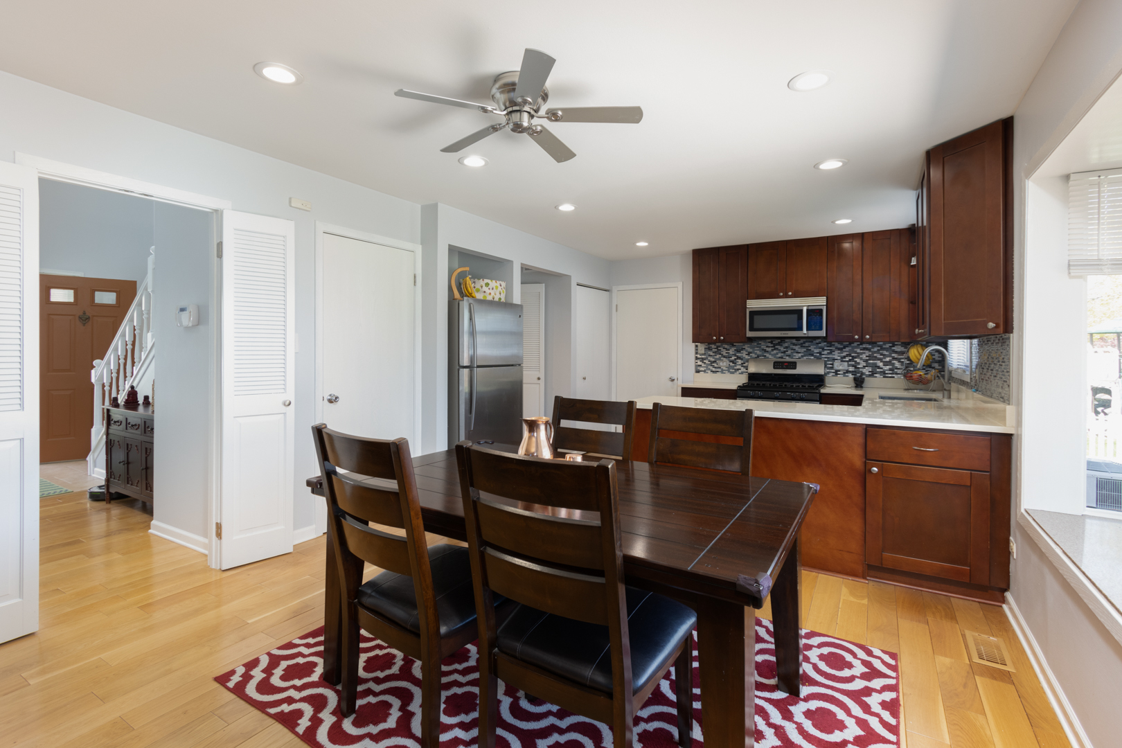 845 Deerpath Lane Hoffman Estates, IL 60169 - Photo 3 of 27 a kitchen with a dining table and chairs