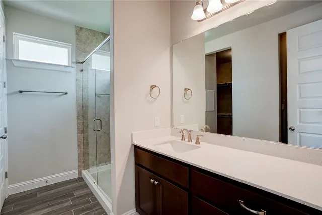 a bathroom with a double vanity sink a and mirror