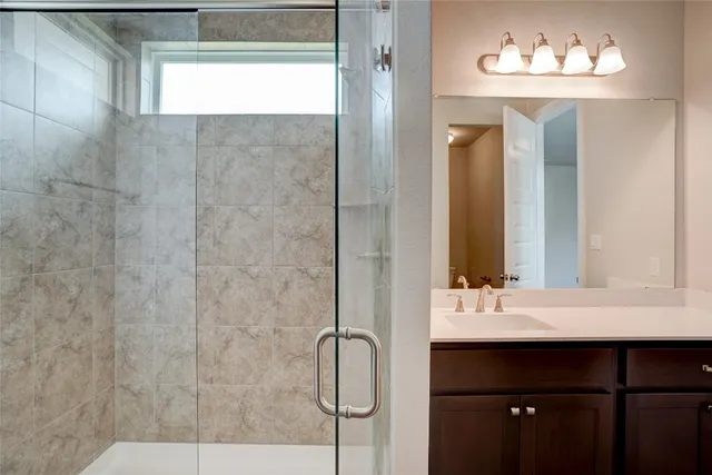 a bathroom with a sink vanity and a mirror