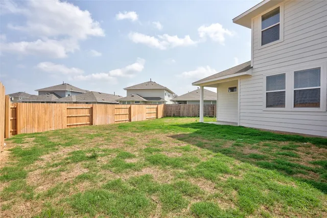a view of a house with backyard and porch