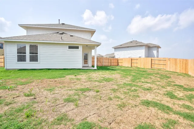 a view of a house with a yard and garage
