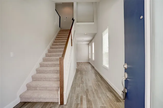 a view of entryway and gallery with wooden floor