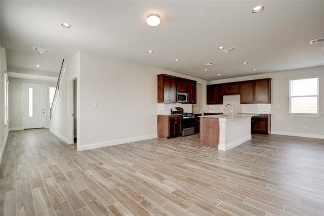 a view of kitchen with microwave and cabinets