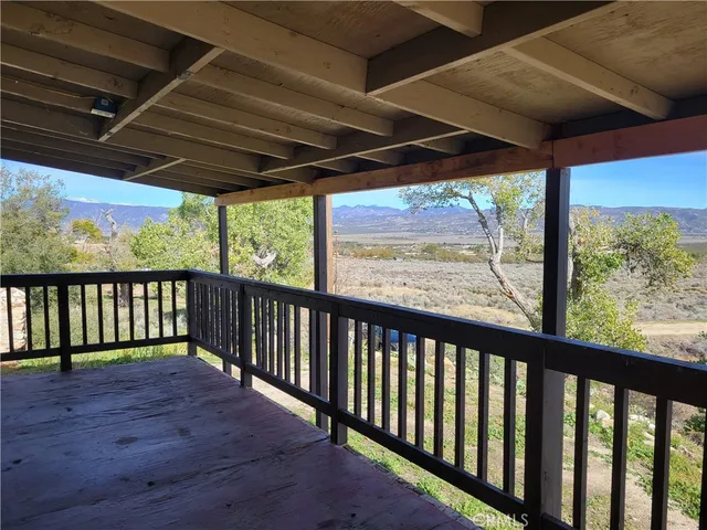 an empty room with a fireplace and window