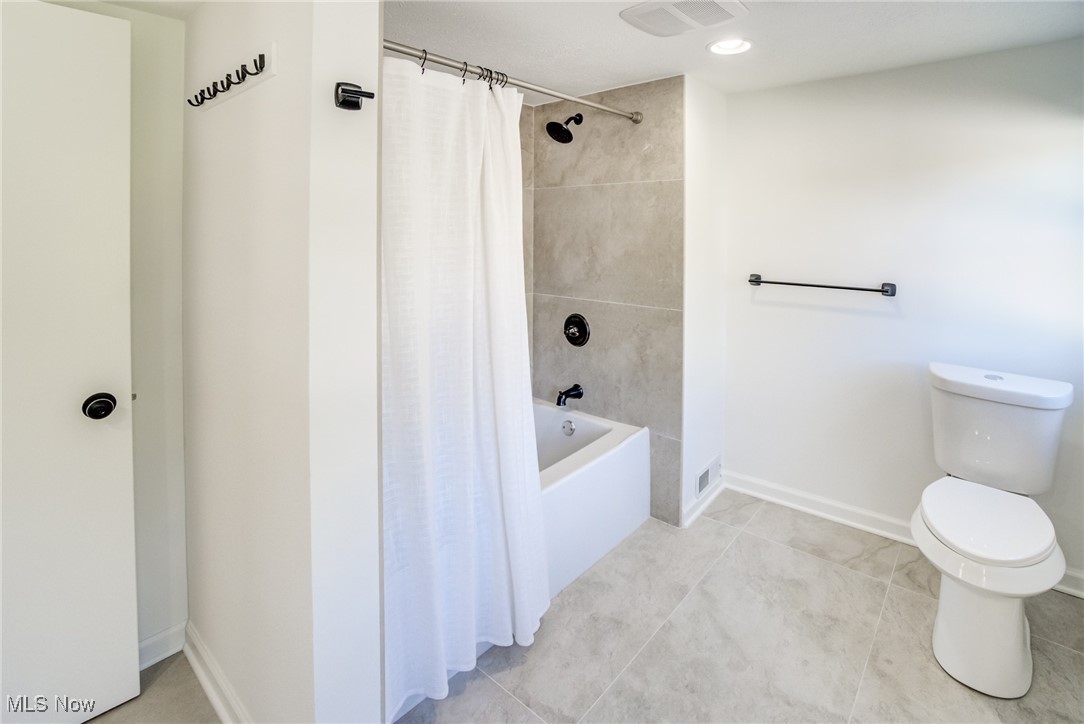 5395 Summit Road Cleveland, OH 44124 - Photo 16 of 28 Bathroom featuring toilet and shower / bath combo with shower curtain