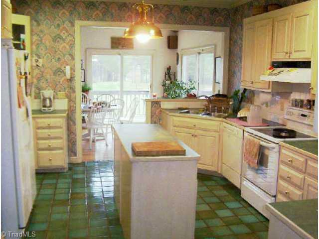 260 Cornatzer Road Mocksville, NC 27028 - Photo 4 of 9 Other. White cabinets, kitchen island, luxurious tile floor.