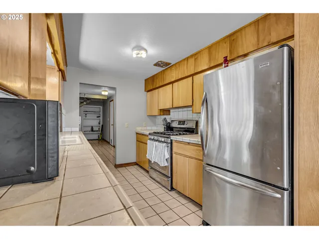 a kitchen with stainless steel appliances a refrigerator and a stove