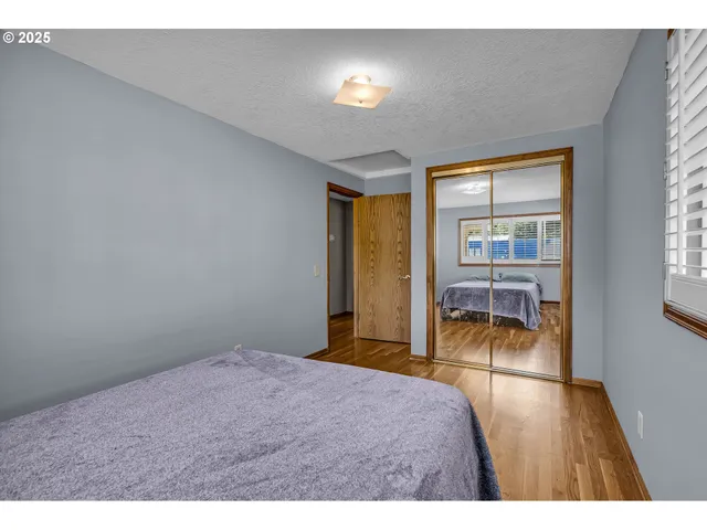 a bedroom with a bed and glass door