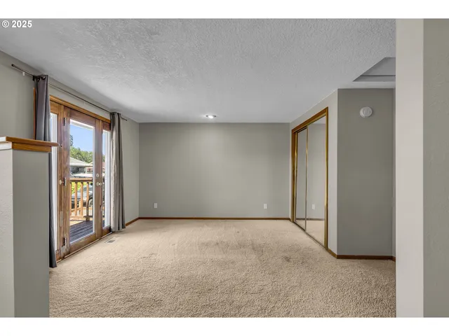 a view of an empty room with glass door