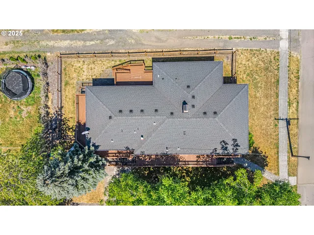 an aerial view of a house with a yard and lake view