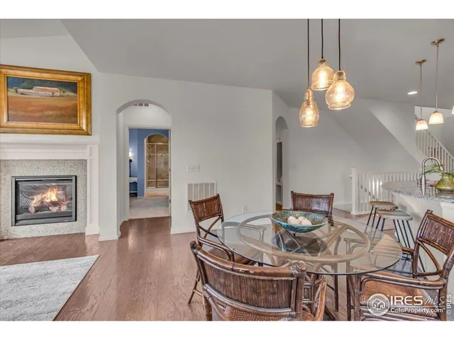 a view of a dining room with furniture wooden floor and chandelier