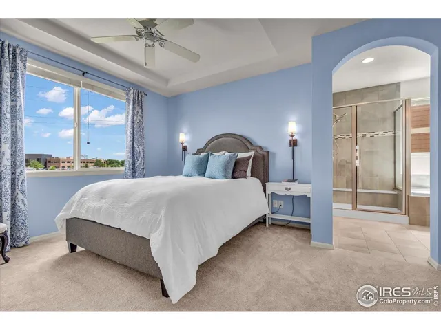 a spacious bedroom with a bed and large window