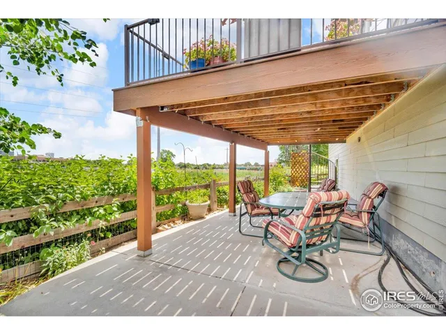 a view of a patio with table and chairs and potted plants