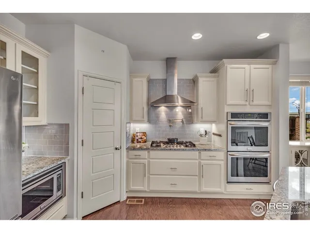 a kitchen with cabinets and stainless steel appliances