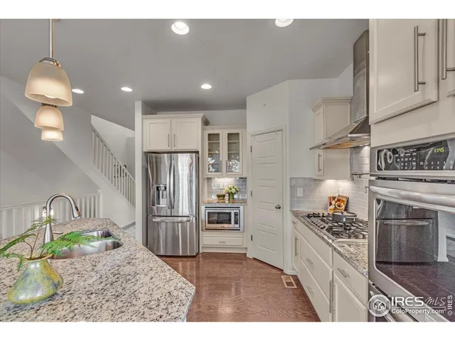 a kitchen with refrigerator cabinets and stove
